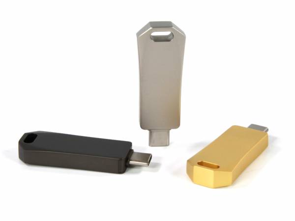 Drei USB-Sticks in verschiedenen Farben (schwarz, silber, gold) mit Platz für individuelles Branding und Logo.